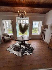 a living room with a table with a bird on it at Firgrove Country House in Robertson