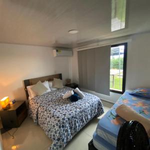 a bedroom with a bed and a window at Finca Campestre en el Lago Calima "Doña Ime" in Calimita +37 photos