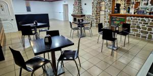 a restaurant with tables and chairs in a room at M&L Gerês in Salamonde