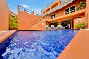 a swimming pool in front of a building at Casa Bella Noche Isla Mujeres in Isla Mujeres