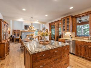 a kitchen with wooden cabinets and a large island at Family Home, Hot Tub, Suncadia Pool Access in Cle Elum