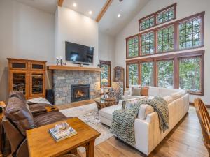 a living room with a couch and a fireplace at Family Home, Hot Tub, Suncadia Pool Access in Cle Elum