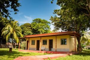 a small yellow house with a porch at Pousada Marajo in Salvaterra