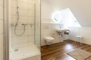 a bathroom with a shower and a toilet and a sink at Grünes Haus in Murau +85 photos