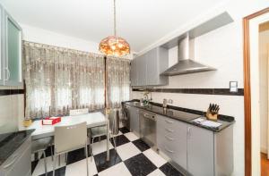 a kitchen with a black and white checkered floor at Soul Etxia in Bermeo