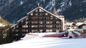 a large building on top of a snow covered mountain at Plagheira 1 in Santa Caterina Valfurva