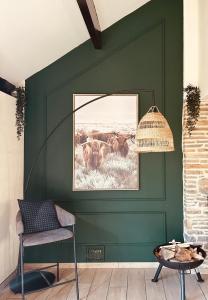 a green wall with a picture of a herd of animals at COCOONING near DINANT 300m from River Meuse in Blaimont