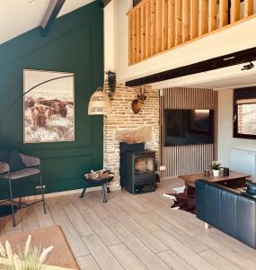 a living room with green walls and a fireplace at COCOONING near DINANT 300m from River Meuse in Blaimont +37 photos