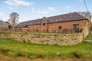 a brick house behind a stone retaining wall at 3 Bed in Sedgehill oc-b34698 in Sedghill