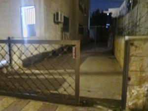 a fence in an empty room with a building at Kamaliyeh studio in Amman