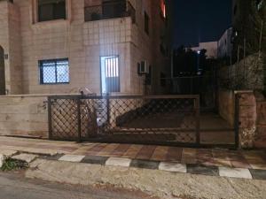 a gate in front of a building at night at Kamaliyeh studio in Amman