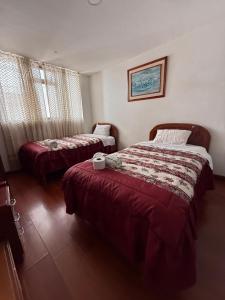 a hotel room with two beds and a window at Hotel Dinastia in Ipiales +7 photos