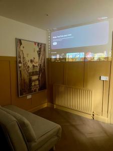 a projection screen in a room with a couch at Dublin City Centre Holiday Let in Dublin