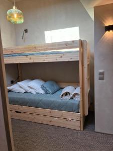 a couple of bunk beds in a room at Loft Cocooning et Lumineux in Arbois