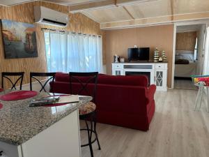 a living room with a red couch and a kitchen at Prime Crystal River location! in Crystal River