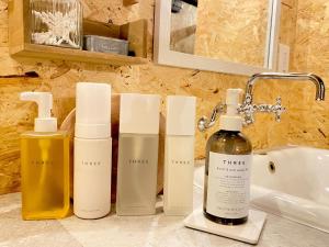 a group of bottles on a counter next to a sink at La Cachette - Vacation STAY 34953v in Ina