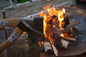 a fire in a forge with flames at La Cachette - Vacation STAY 34953v in Ina