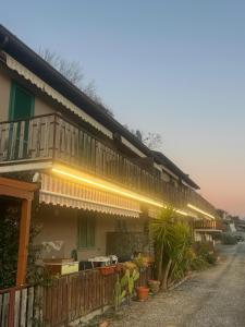 a house with lights on the side of it at La Dimora del Lago d'Iseo in Sarnico