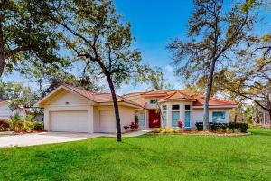 a house with a green lawn and trees at Golfer's Oasis w/ Pool in Black Diamond Ranch! in Lecanto