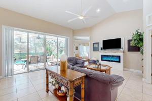 a living room with a couch and a tv at Golfer's Oasis w/ Pool in Black Diamond Ranch! in Lecanto