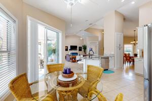 a kitchen and dining room with a glass table and chairs at Golfer's Oasis w/ Pool in Black Diamond Ranch! in Lecanto