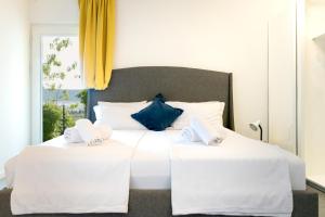 a bedroom with two white beds and a window at OleaVista in Portorož