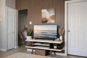 a living room with a flat screen tv on a table at Jefferson - 20 mins to Manhattan, NYC in West New York