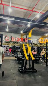 a group of people in a gym with yellow equipment at Hotel Mirage in Vilhena
