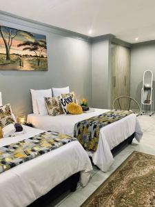 two beds sitting next to each other in a room at Lady D Exclusive Abode in Polokwane +85 photos