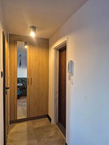 a hallway with a door and a phone on the wall at Apartament Serbinowska in Kalisz