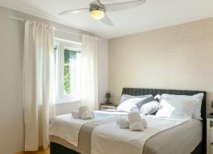 a bedroom with a large bed with white pillows at OleaVista in Portorož +88 photos