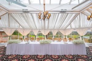 a long table with chairs and a chandelier at The Belfray Country Inn in Derry Londonderry