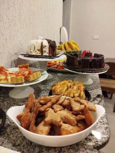 a table with different types of cakes and pies at Hotel Lider in Paranaguá