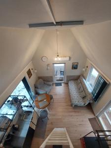 an overhead view of a living room with a table at small house "Urgas" by the sea with 6 beds in Plieņciems