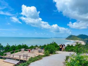 a group of people standing on top of a beach at Mia's Homestay in Quang Ninh