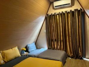 a small bedroom with two beds and a window at Mia's Homestay in Quang Ninh