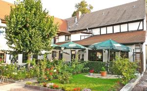 a building with a garden in front of it at Hotel Lindenhof in Bad Lauchstädt