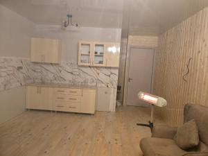 eine Küche mit Sofa und Lampe in einem Zimmer in der Unterkunft goderdzi apartaments in Danisparauli