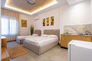 a hotel room with two beds and a kitchen at Lalun Aparts in Golem +146 photos