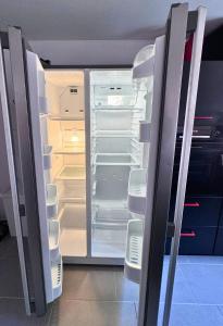 an empty refrigerator with its door open in a room at Weserblick Hafen-Haus-Bremen in Bremen