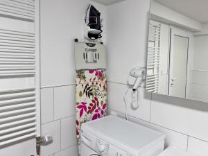 a small bathroom with a washing machine and a mirror at Weserblick Hafen-Haus-Bremen in Bremen +76 photos
