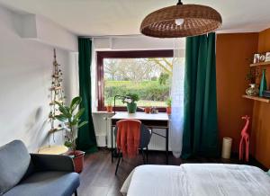 a bedroom with a bed and a desk and a window at Weserblick Hafen-Haus-Bremen in Bremen