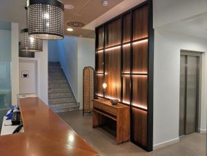 a hallway with a table and a staircase at Hotel Santa Rosa, Blue Hoteles in Gijón