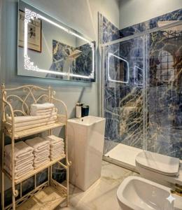 a bathroom with a toilet and a glass shower at Villa Leonardo House Pisa Secret Garden in Pisa