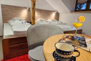 a room with a table and chairs and a bed and a bedroom at Hotel Protea Bolesławiec in Bolesławiec