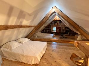 a bedroom with a bed in a attic at La grange du dévoluy in Le Dévoluy