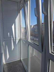 an empty room with three windows in a building at Апартаменты возле отеля Украина in Chernihiv