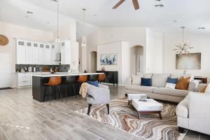 a kitchen and living room with a couch and a table at Sandcastle House Pool, Spa, Golf! in Queen Creek
