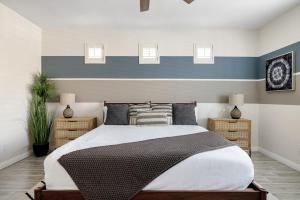 a bedroom with a bed with a blue and white wall at Sandcastle House Pool, Spa, Golf! in Queen Creek +25 photos