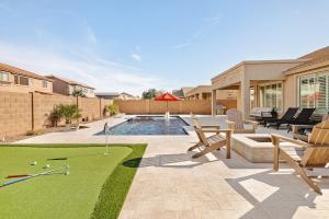 a backyard with a pool with a putting green at Sandcastle House Pool, Spa, Golf! in Queen Creek